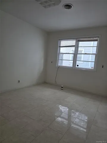 an empty room with a empty space and windows