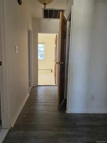 an empty room with wooden floor and closet