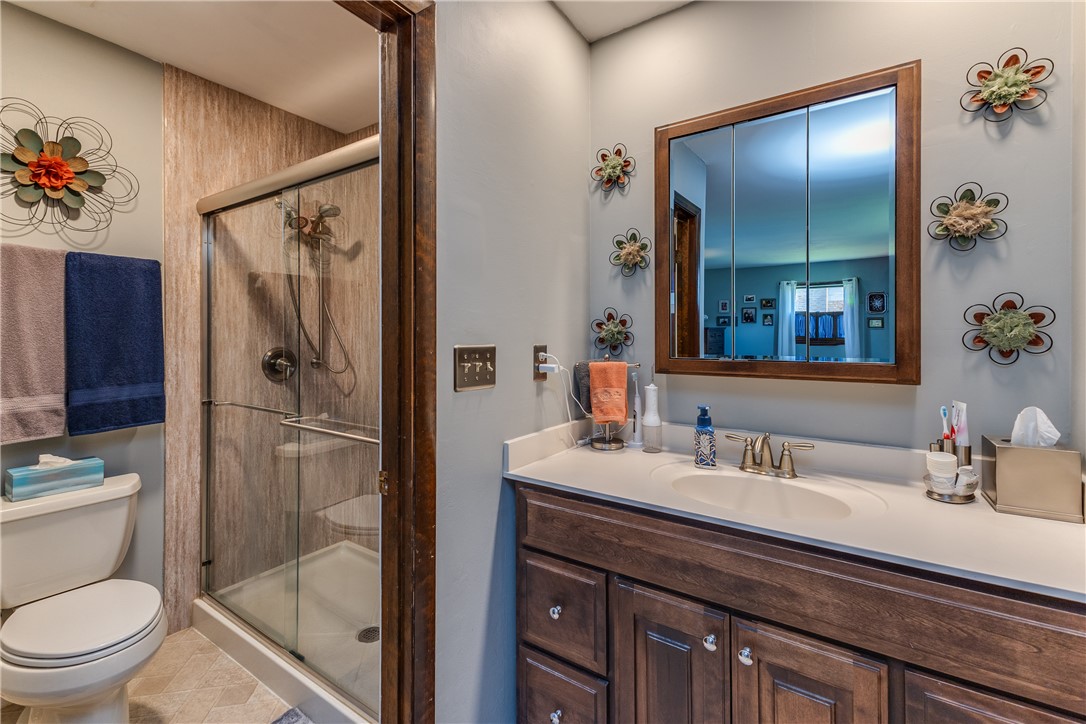 4210 Pleasanton Road Englewood, OH 45322 - Photo 20 of 34 This bright bathroom features a vanity with a sleek countertop and an inviting shower area.