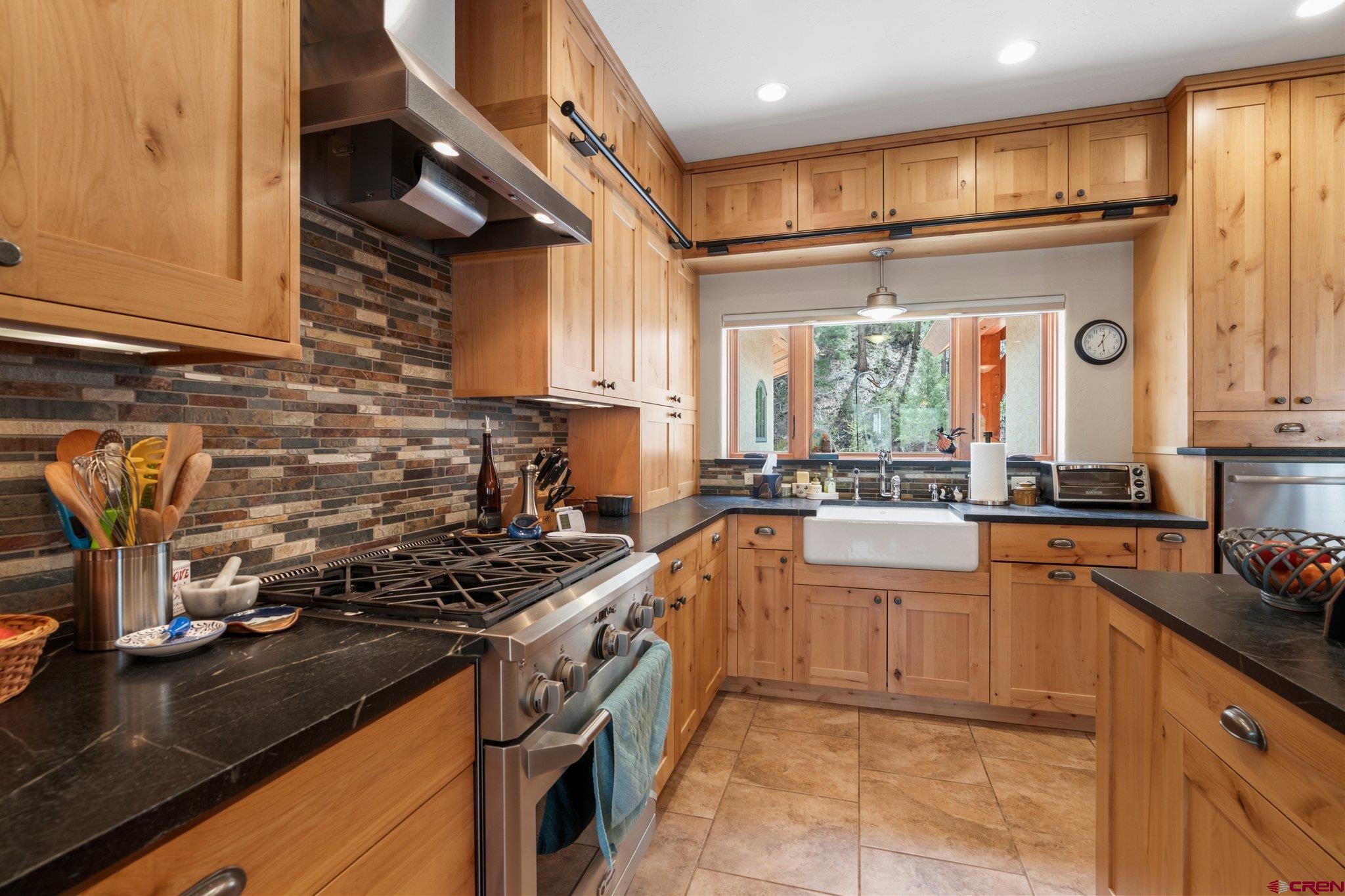 99 River Road Durango, CO 81301 - Photo 11 of 44 a kitchen with stainless steel appliances granite countertop a stove a sink and a microwave