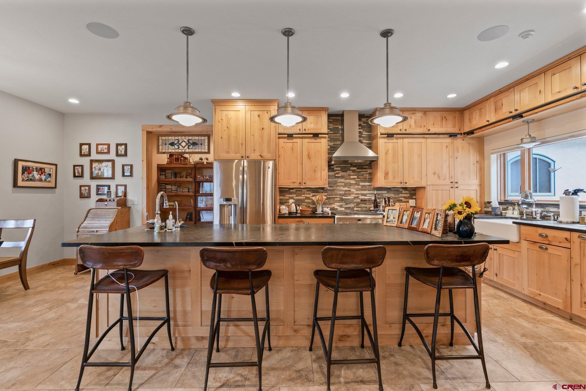 99 River Road Durango, CO 81301 - Photo 13 of 44 a kitchen with stainless steel appliances kitchen island a large island in the center