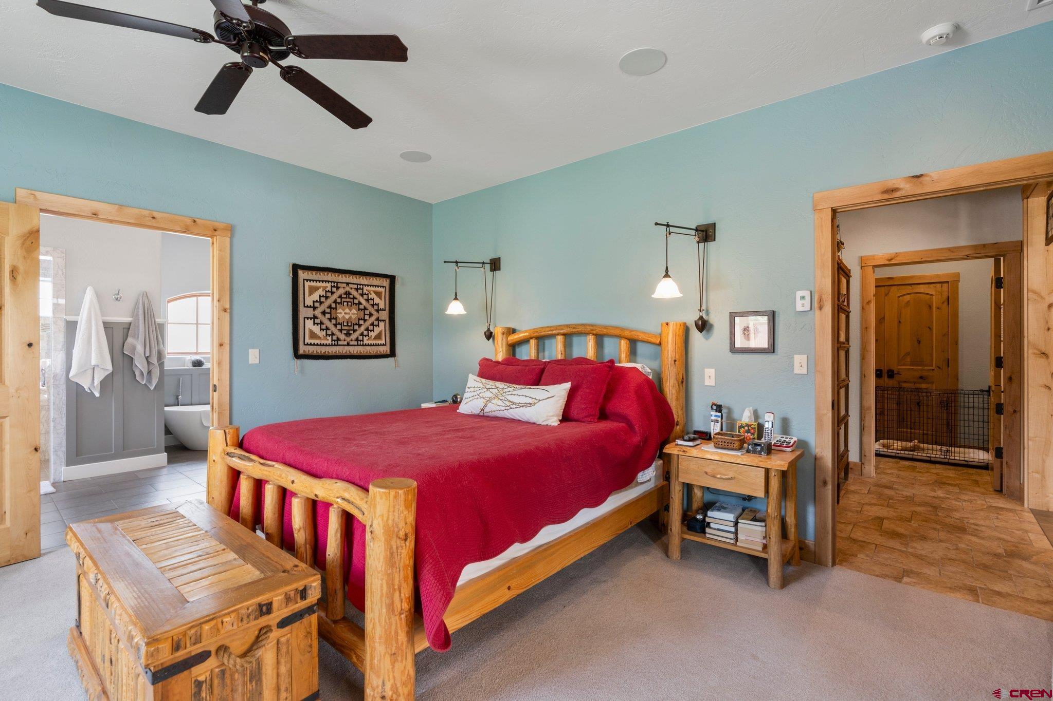 99 River Road Durango, CO 81301 - Photo 17 of 44 a bedroom with a bed and a chandelier
