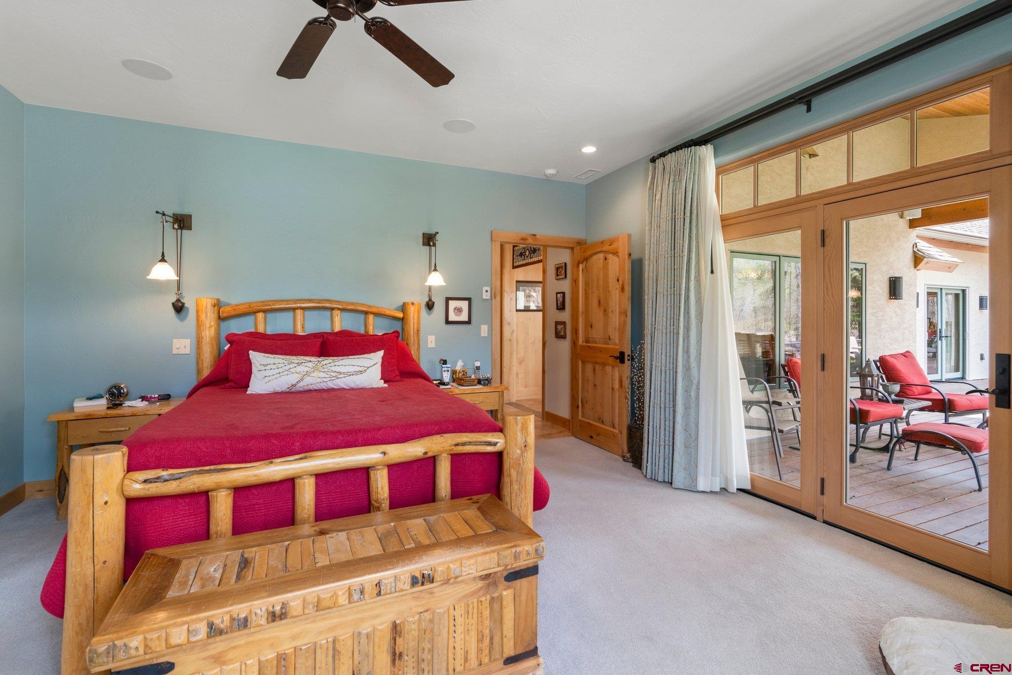 99 River Road Durango, CO 81301 - Photo 18 of 44 a bedroom with a bed and glass door
