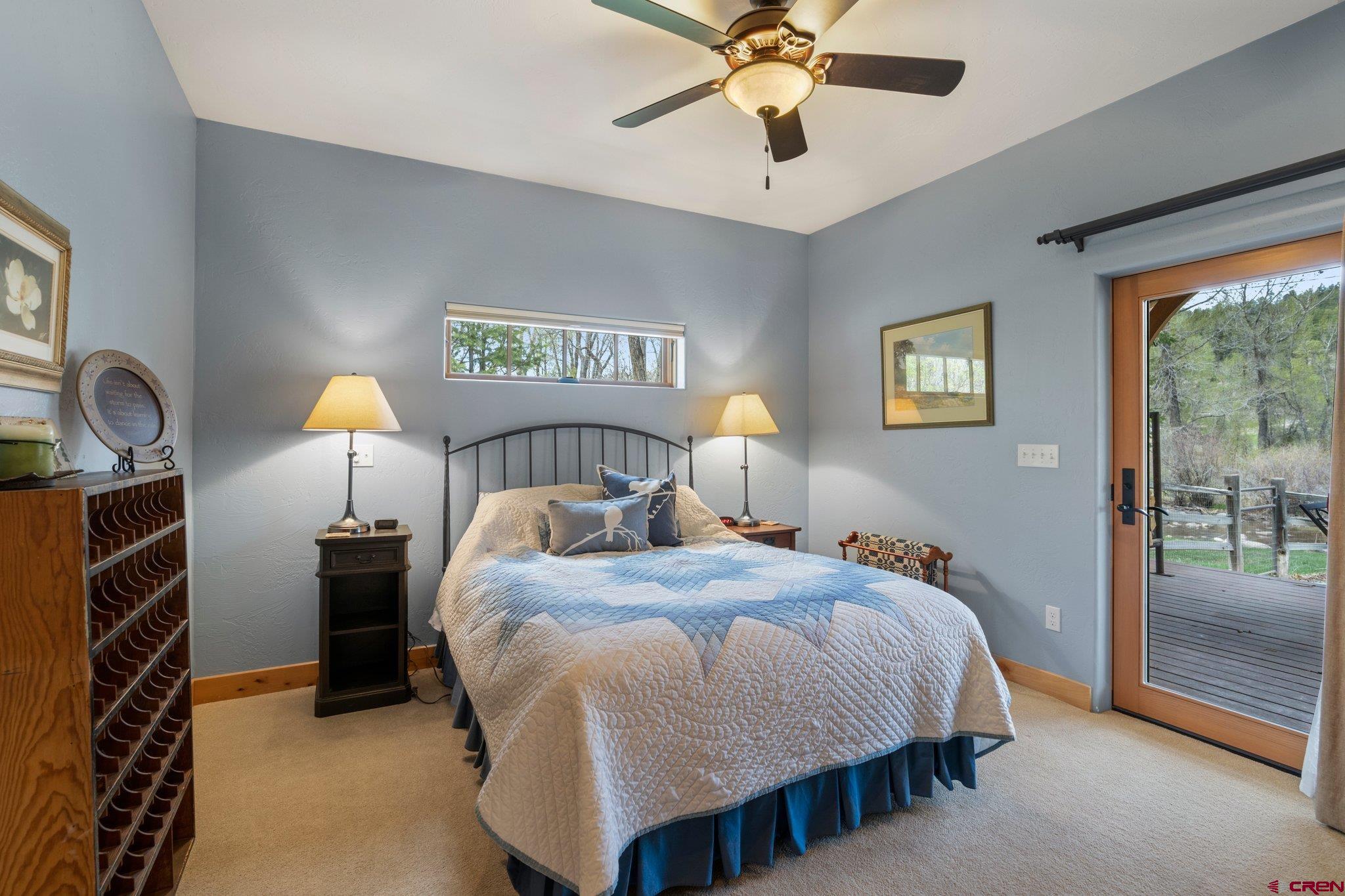 99 River Road Durango, CO 81301 - Photo 24 of 44 a bedroom with a bed and a chandelier