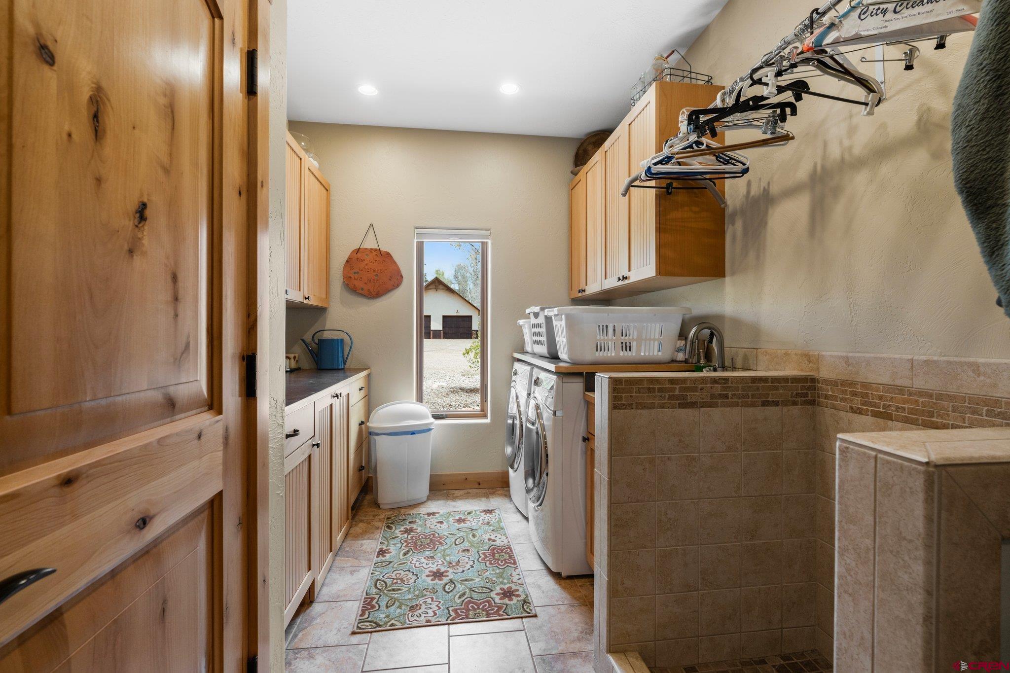 99 River Road Durango, CO 81301 - Photo 29 of 44 a bathroom with a granite countertop sink a toilet and shower