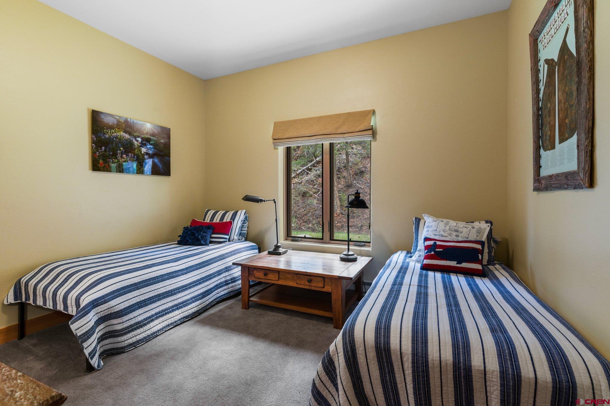 99 River Road Durango, CO 81301 - Photo 34 of 44 a bedroom with a bed and wooden floor