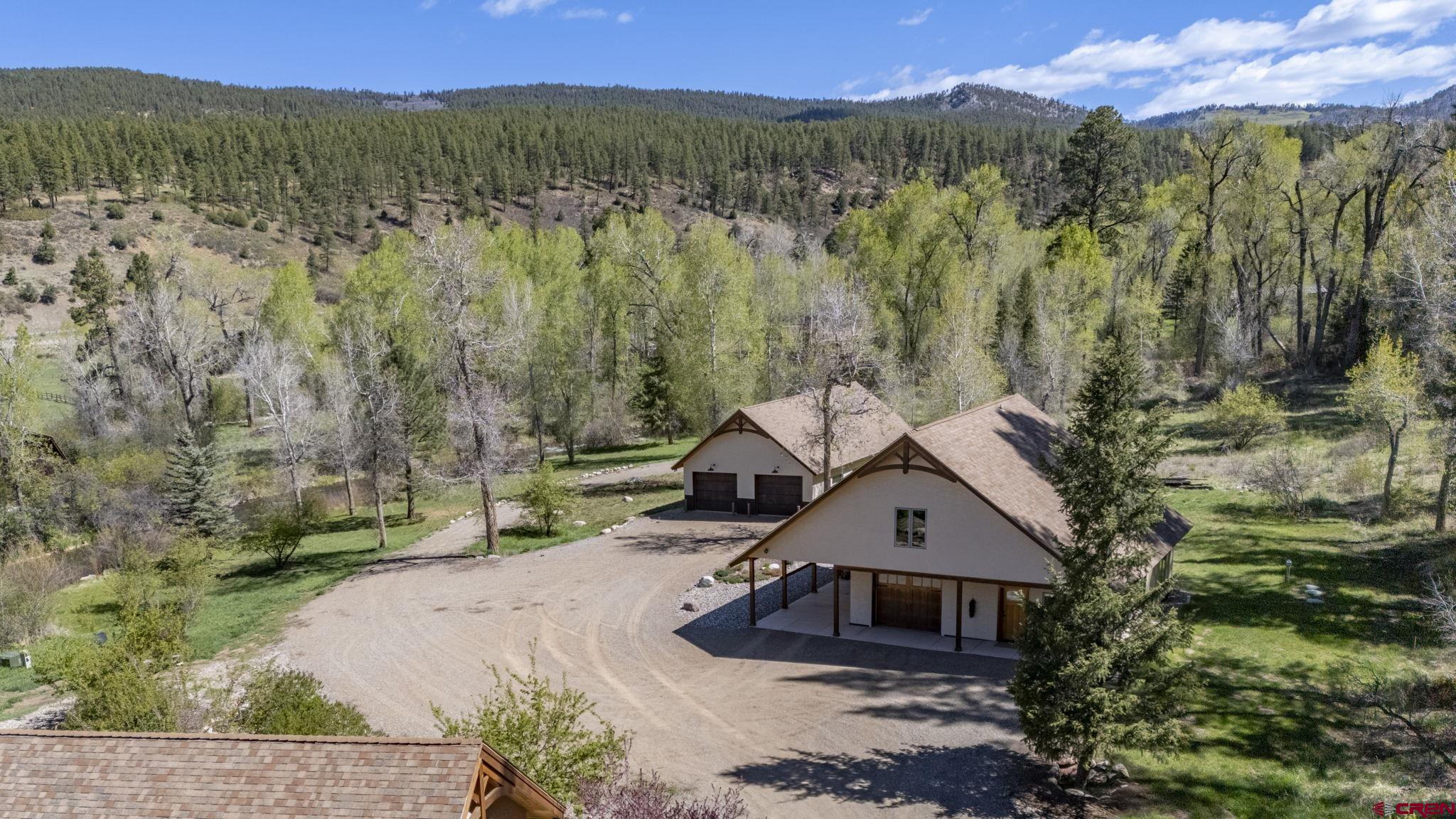 99 River Road Durango, CO 81301 - Photo 40 of 44 a view of a house with a yard and mountain in the background