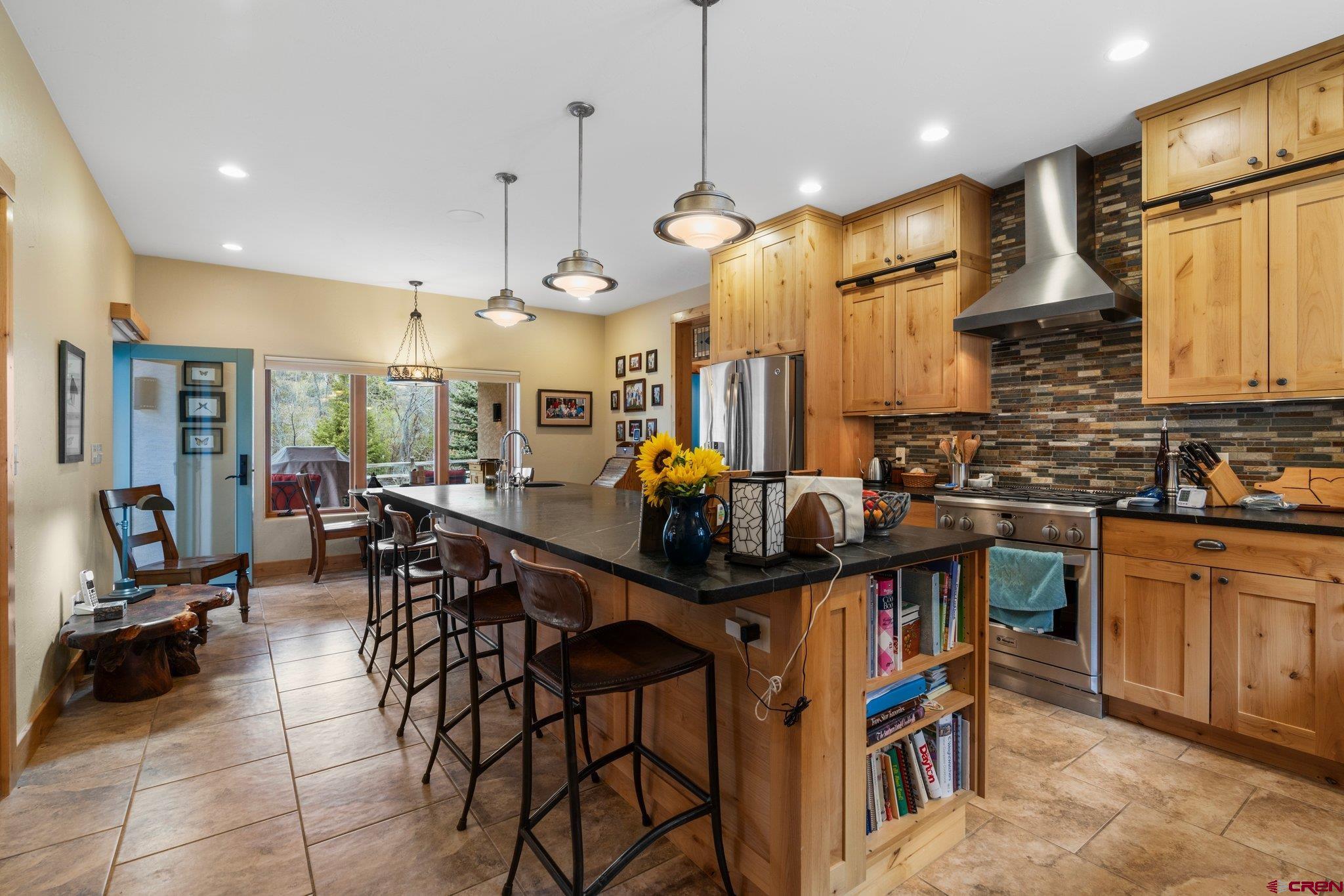 99 River Road Durango, CO 81301 - Photo 10 of 44 a kitchen with stainless steel appliances granite countertop a sink a stove and a wooden floors