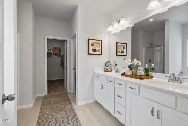 a spacious bathroom with a double vanity sink and a mirror
