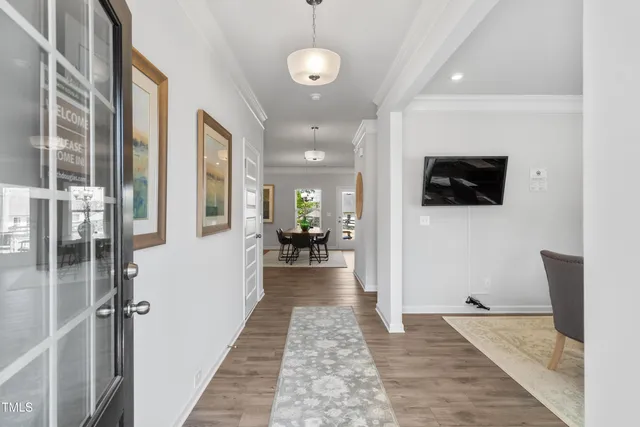 a view of a hallway with the living room and wooden floor
