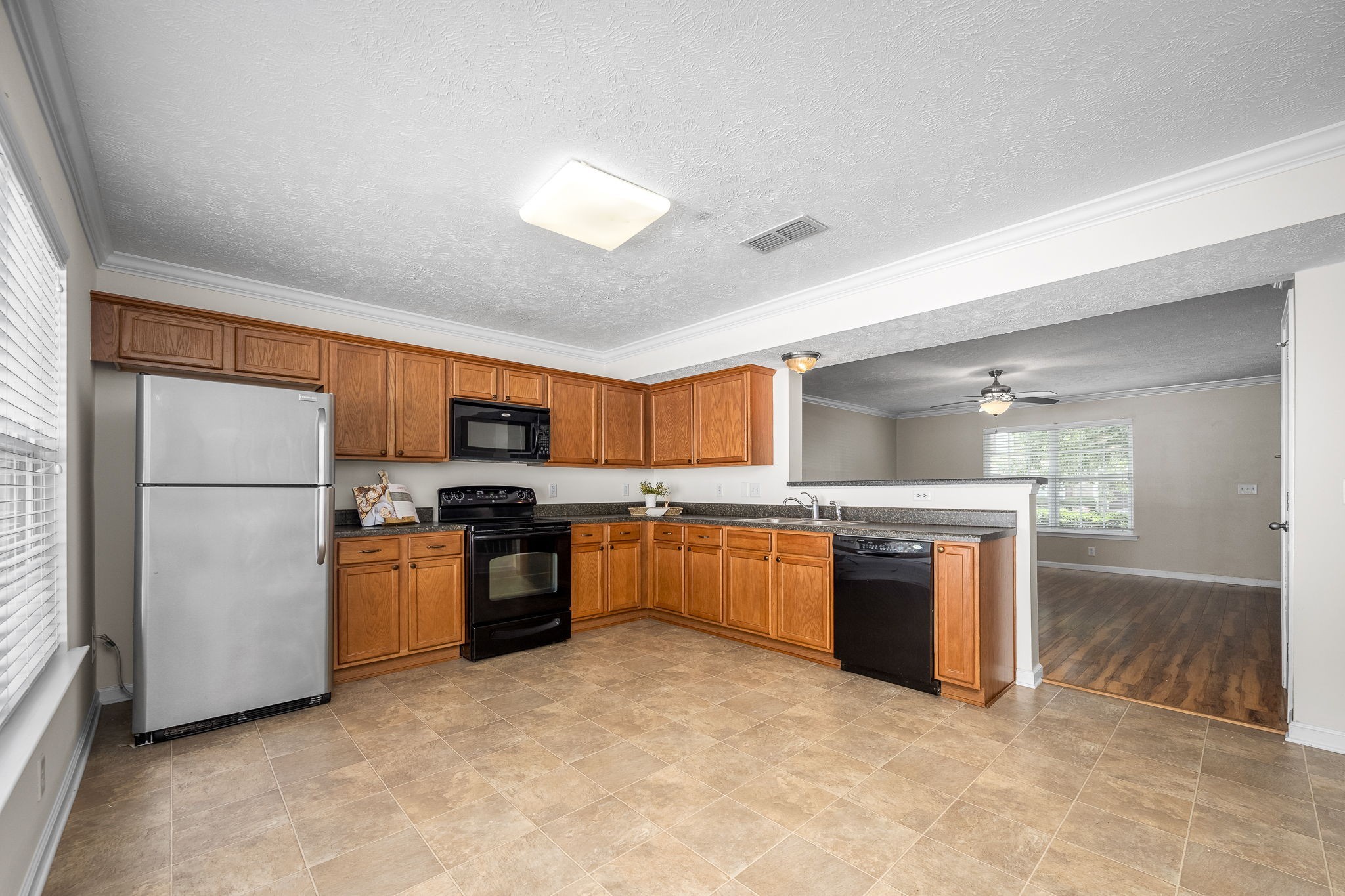 3216 Terrapin Court Murfreesboro, TN 37128 - Photo 6 of 17 a kitchen with stainless steel appliances granite countertop a stove top oven a sink a refrigerator and white cabinets