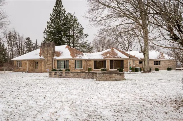 a wooden house with trees in front of it