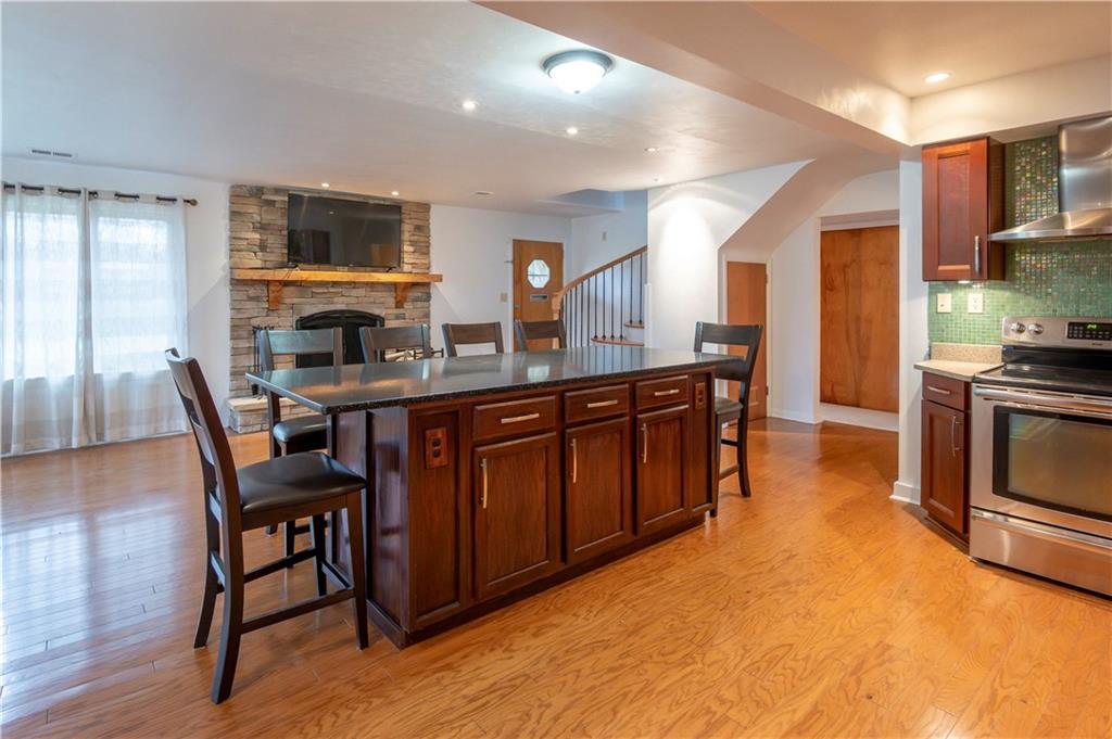 235 Highview Avenue Pittsburgh, PA 15238 - Photo 15 of 39 a kitchen with stainless steel appliances granite countertop a stove a sink dishwasher and a refrigerator with wooden floor