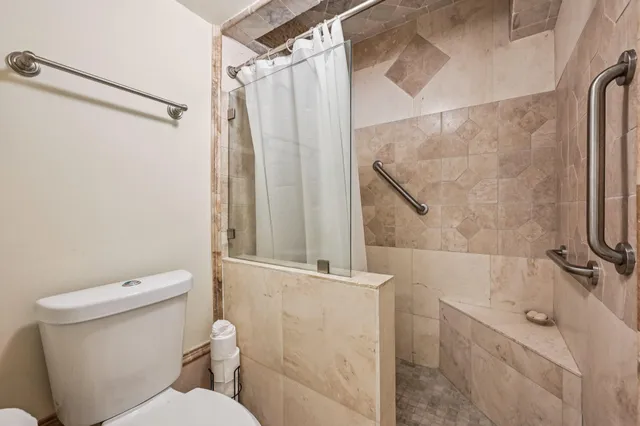 a view of hallway with cabinets and chandelier