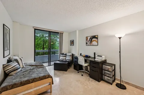 a bedroom with a large bed and a desk