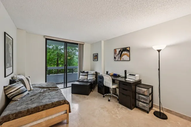 a bedroom with a large bed and a desk