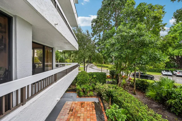 an aerial view of multi story residential apartment building with yard