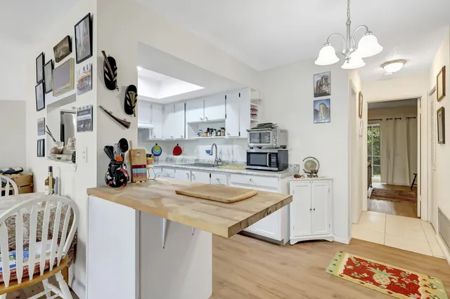 a view of a kitchen area with furniture and wooden floor