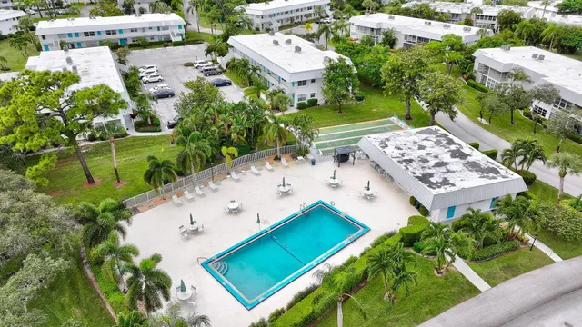 an aerial view of a house with a garden and lake view