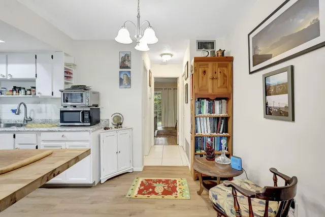 a living room with furniture and a kitchen view