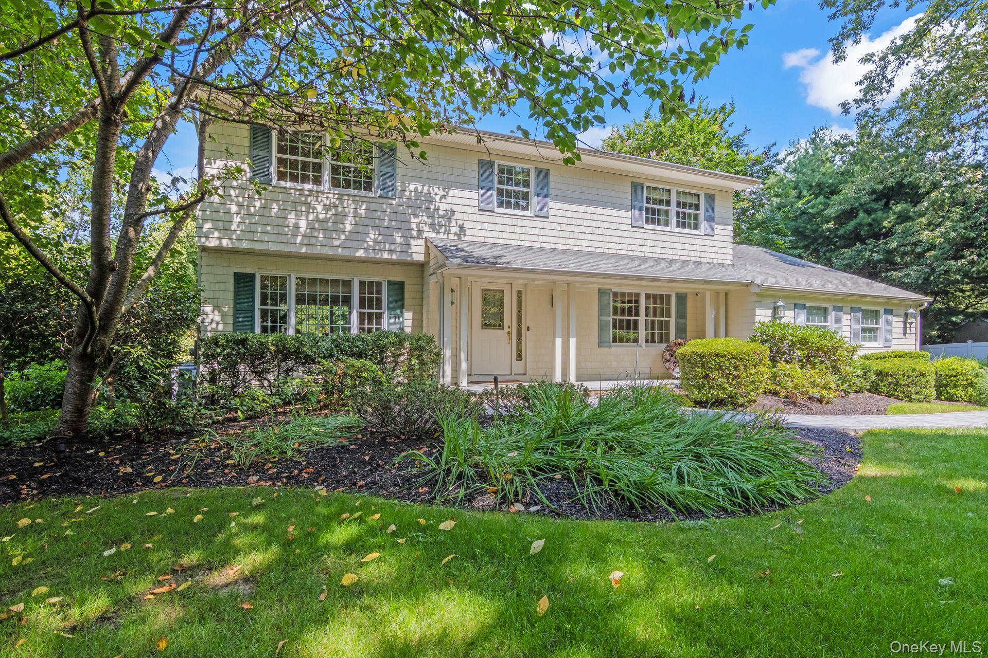 Traditional home with a front yard and a porch