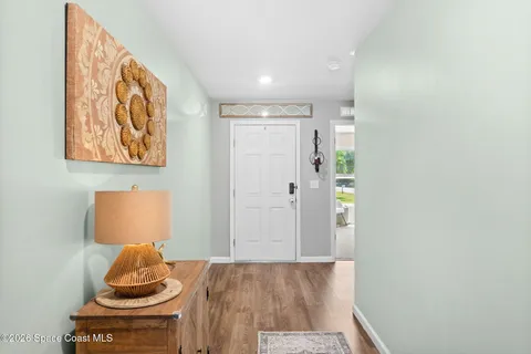 a view of hallway with bed and a couch