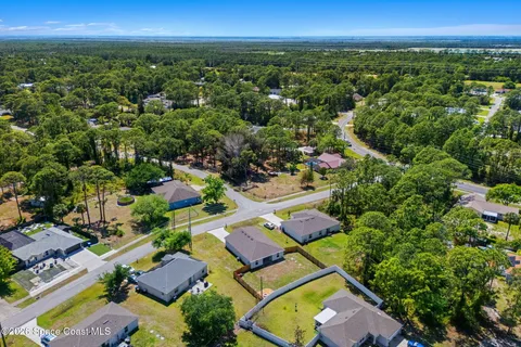 an aerial view of residential houses with outdoor space