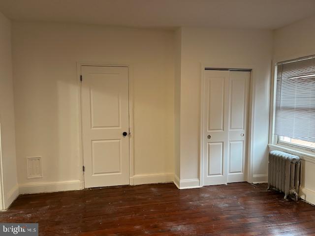 1508 Lombard Street, Unit 3F Philadelphia, PA 19146 - Photo 3 of 9 a view of an empty room with wooden floor and a window