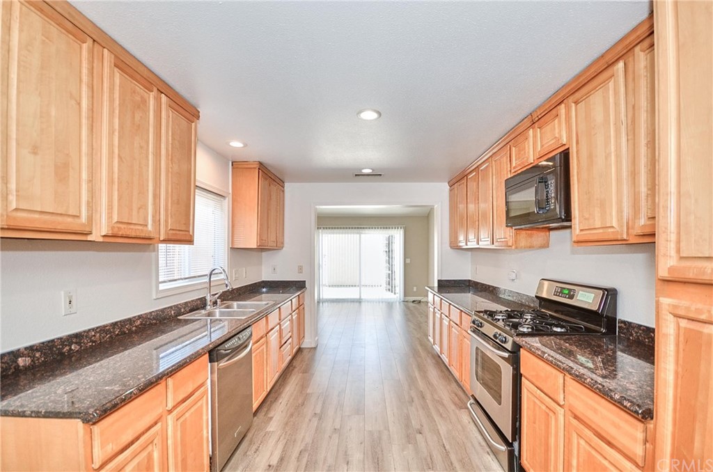 18319 Norwalk Boulevard Artesia, CA 90701 - Photo 13 of 39 a kitchen with stainless steel appliances granite countertop a stove a sink and a refrigerator