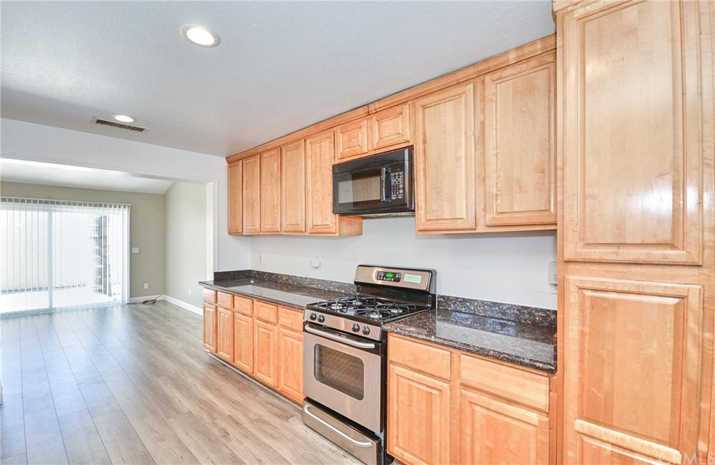 18319 Norwalk Boulevard Artesia, CA 90701 - Photo 14 of 39 a kitchen with stainless steel appliances granite countertop a stove a sink and a refrigerator