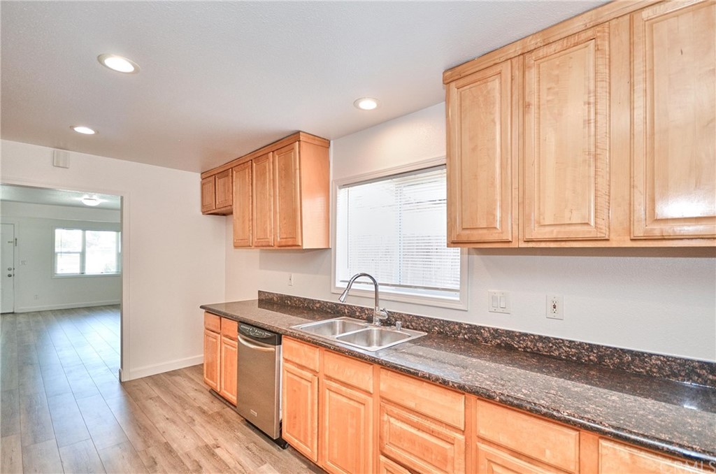 18319 Norwalk Boulevard Artesia, CA 90701 - Photo 15 of 39 a kitchen with granite countertop a sink stainless steel appliances and cabinets