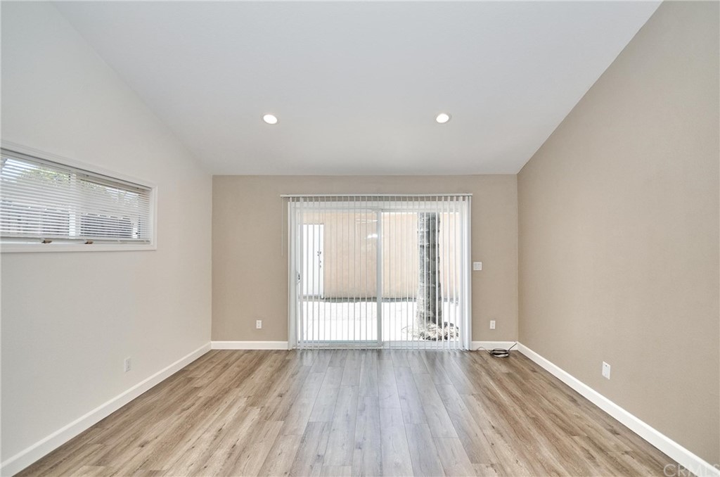 18319 Norwalk Boulevard Artesia, CA 90701 - Photo 17 of 39 wooden floor in an empty room with a window