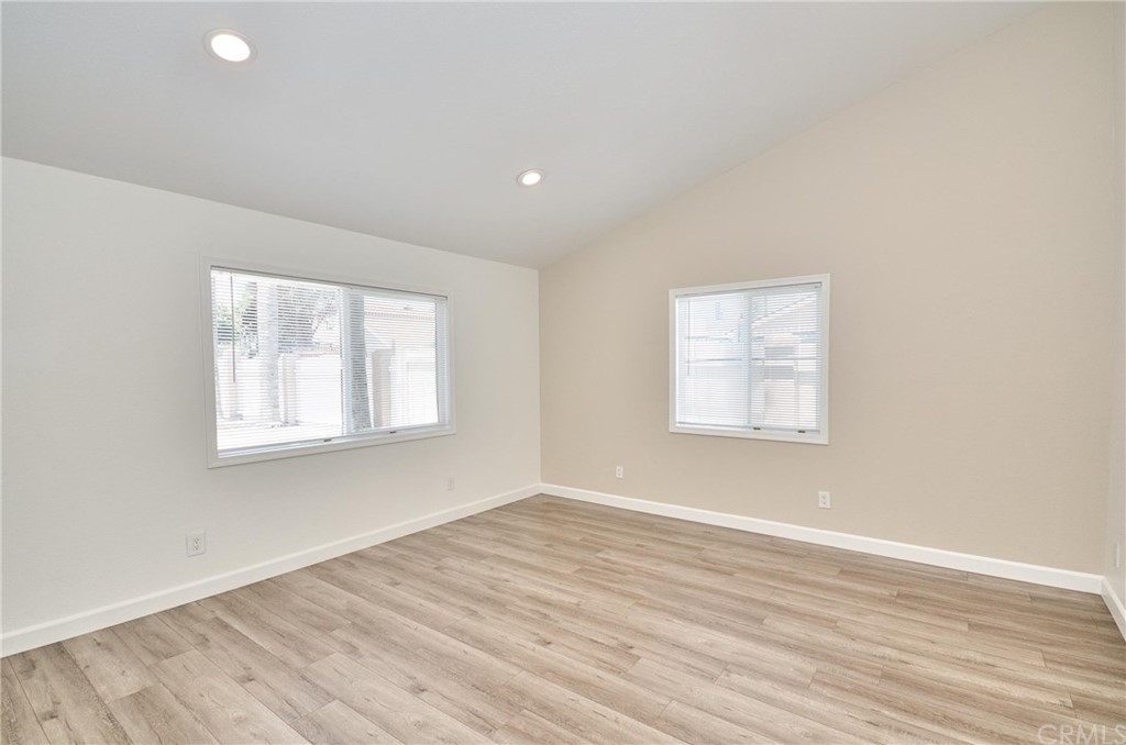 18319 Norwalk Boulevard Artesia, CA 90701 - Photo 19 of 39 an empty room with wooden floor and windows
