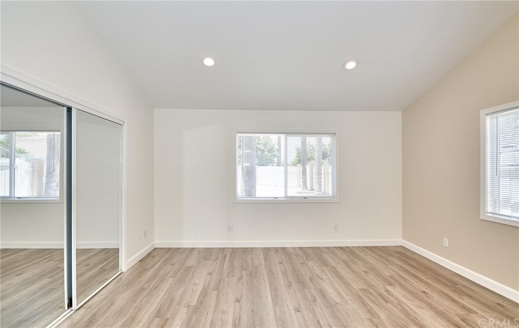 18319 Norwalk Boulevard Artesia, CA 90701 - Photo 20 of 39 an empty room with wooden floor and windows