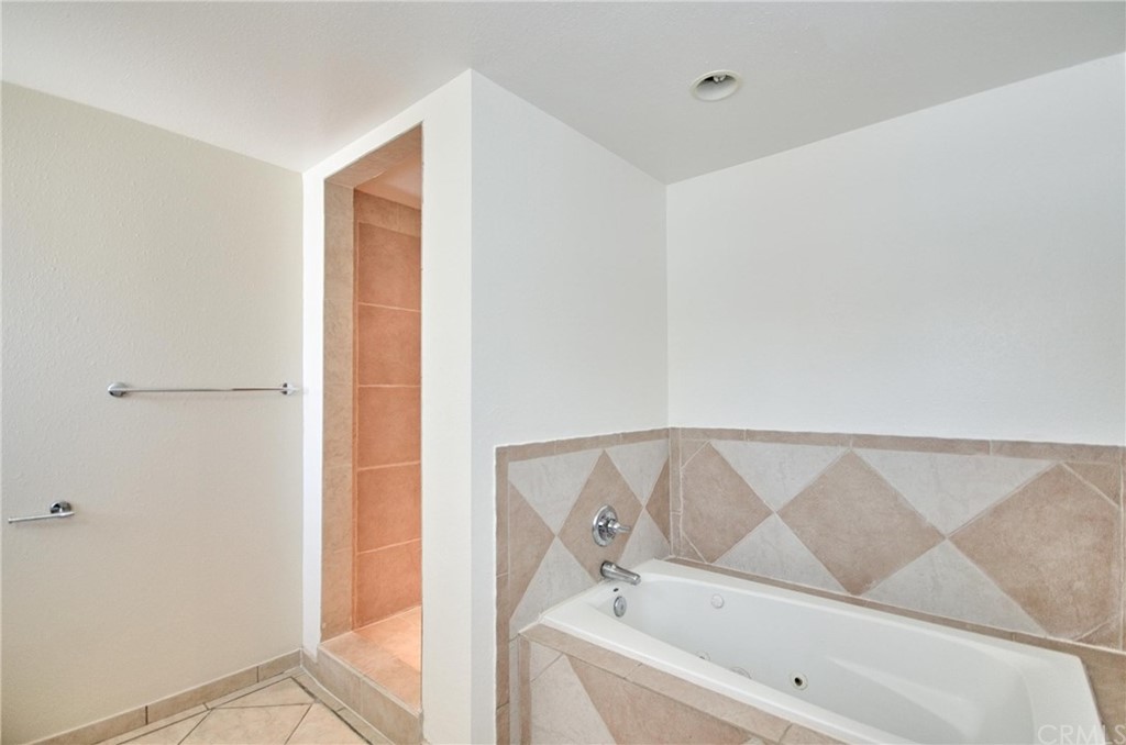 18319 Norwalk Boulevard Artesia, CA 90701 - Photo 24 of 39 a bathroom with a bathtub and a shower