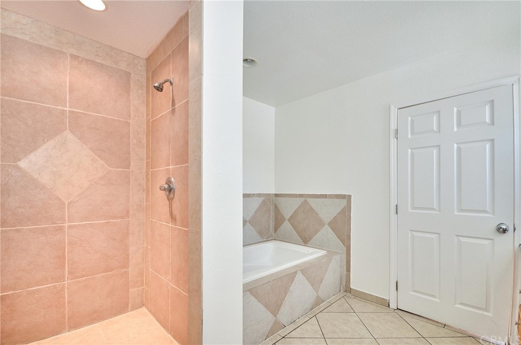 18319 Norwalk Boulevard Artesia, CA 90701 - Photo 25 of 39 a bathroom with a bathtub and a shower