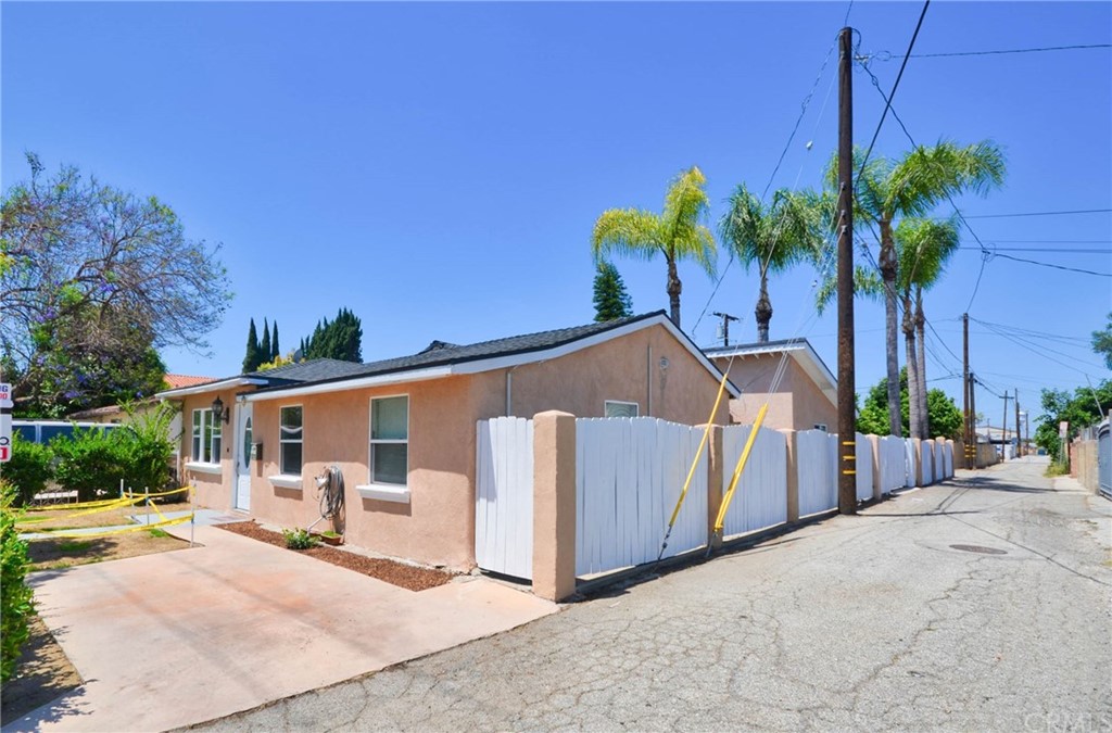 18319 Norwalk Boulevard Artesia, CA 90701 - Photo 34 of 39 a view of a house with backyard and a tree