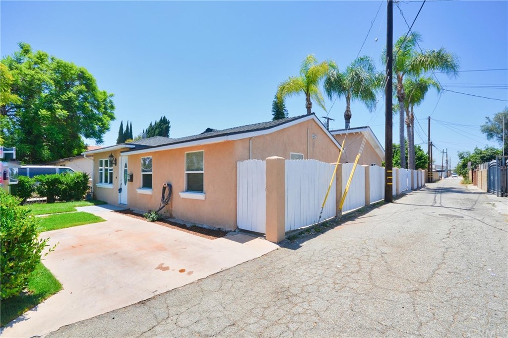 18319 Norwalk Boulevard Artesia, CA 90701 - Photo 35 of 39 a front view of a house with a yard and potted plants
