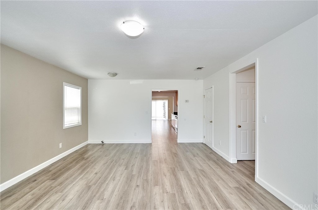 18319 Norwalk Boulevard Artesia, CA 90701 - Photo 5 of 39 a view of an empty room with wooden floor and window