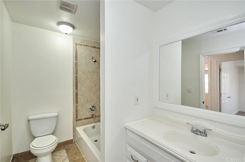 18319 Norwalk Boulevard Artesia, CA 90701 - Photo 9 of 39 a bathroom with a sink a toilet and shower