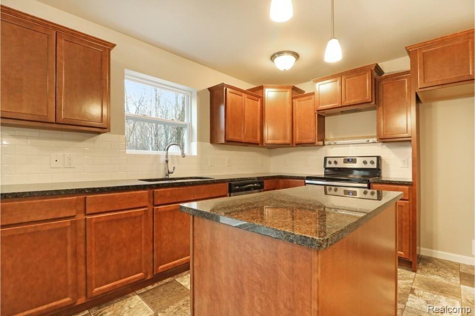 42826 Colonial Road Belleville, MI 48111 - Photo 12 of 33 There is a large island in the Kitchen with pendant lighting above