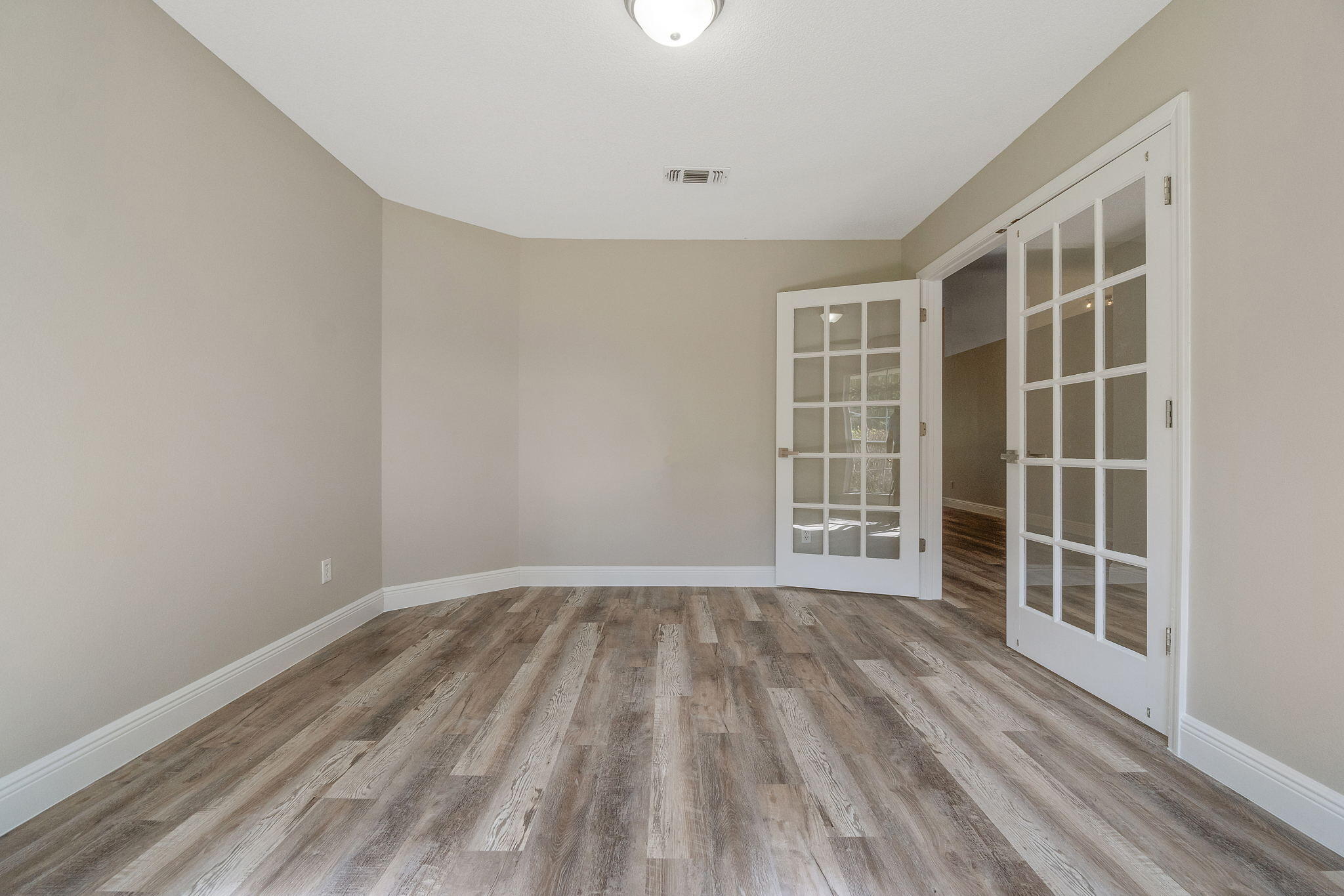 2005 Cardinal Lane Navarre, FL 32566 - Photo 11 of 63 a view of empty room with wooden floor and fan