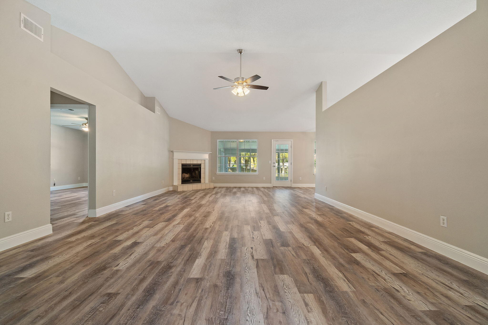 2005 Cardinal Lane Navarre, FL 32566 - Photo 12 of 63 wooden floor in an empty room with a window