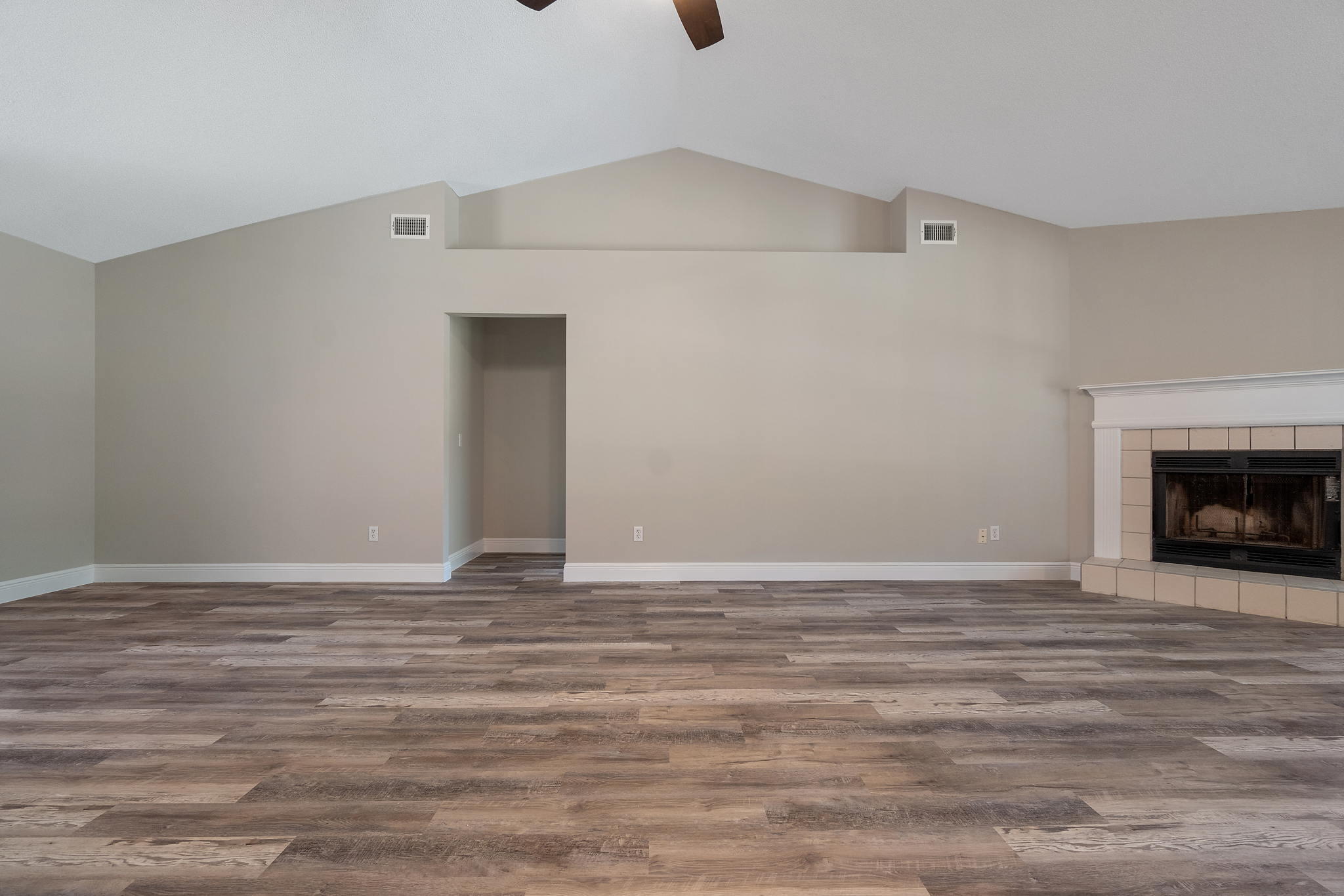 2005 Cardinal Lane Navarre, FL 32566 - Photo 15 of 63 a view of an empty room with wooden floor and a fireplace
