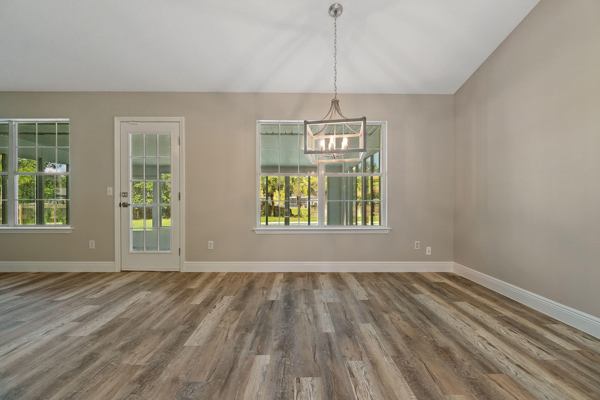 2005 Cardinal Lane Navarre, FL 32566 - Photo 17 of 63 a view of an empty room with a window and wooden floor