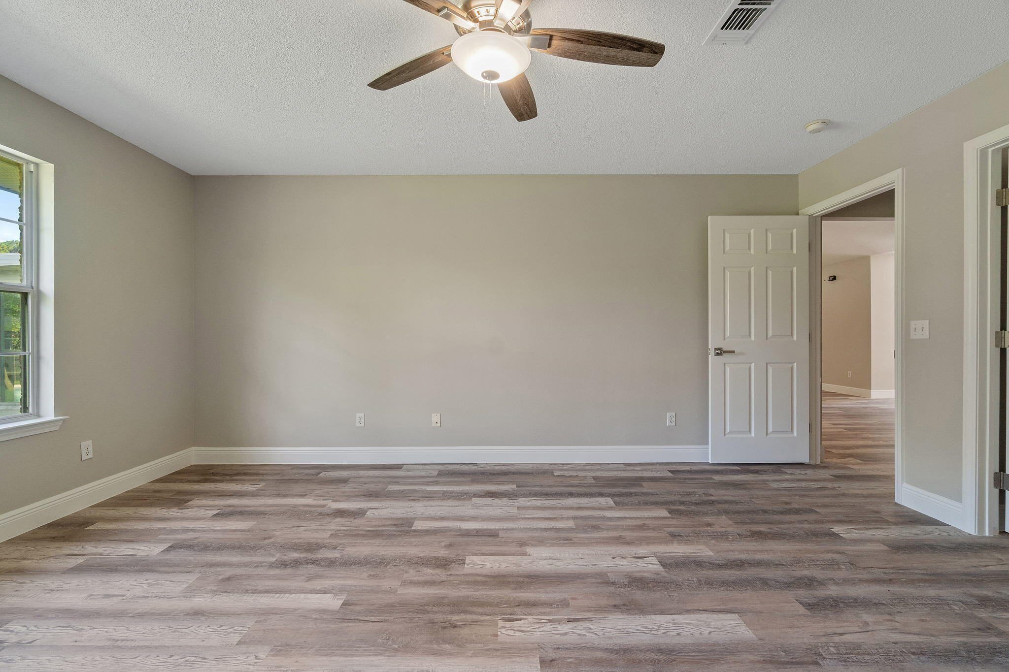 2005 Cardinal Lane Navarre, FL 32566 - Photo 24 of 63 a view of an empty room with wooden floor and a window