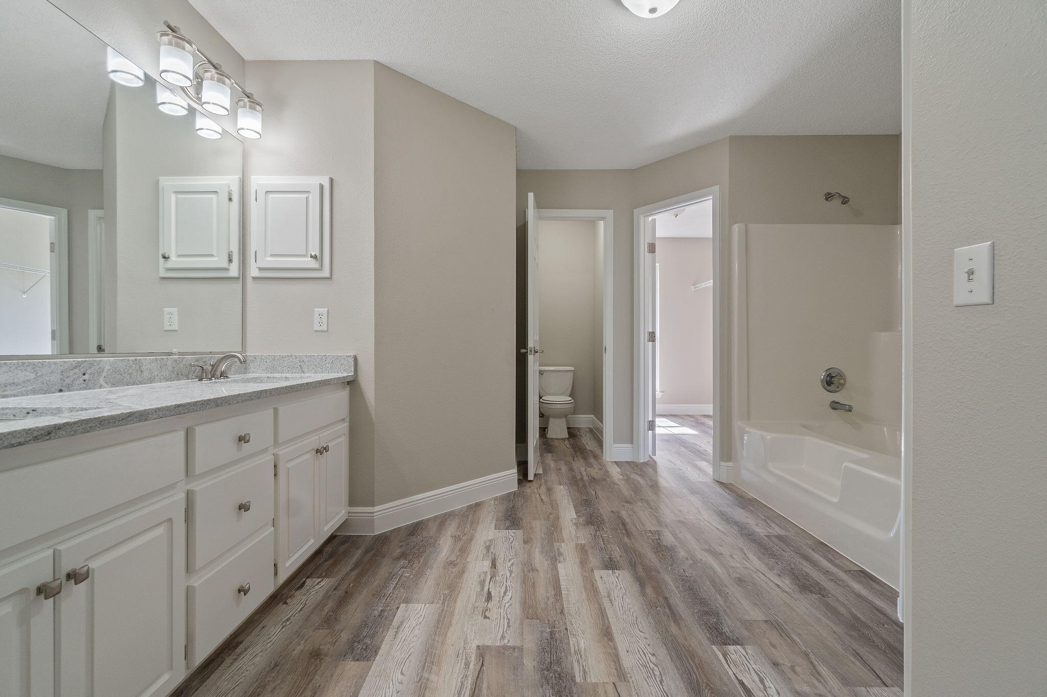 2005 Cardinal Lane Navarre, FL 32566 - Photo 27 of 63 a bathroom with a sink a mirror a vanity and a shower