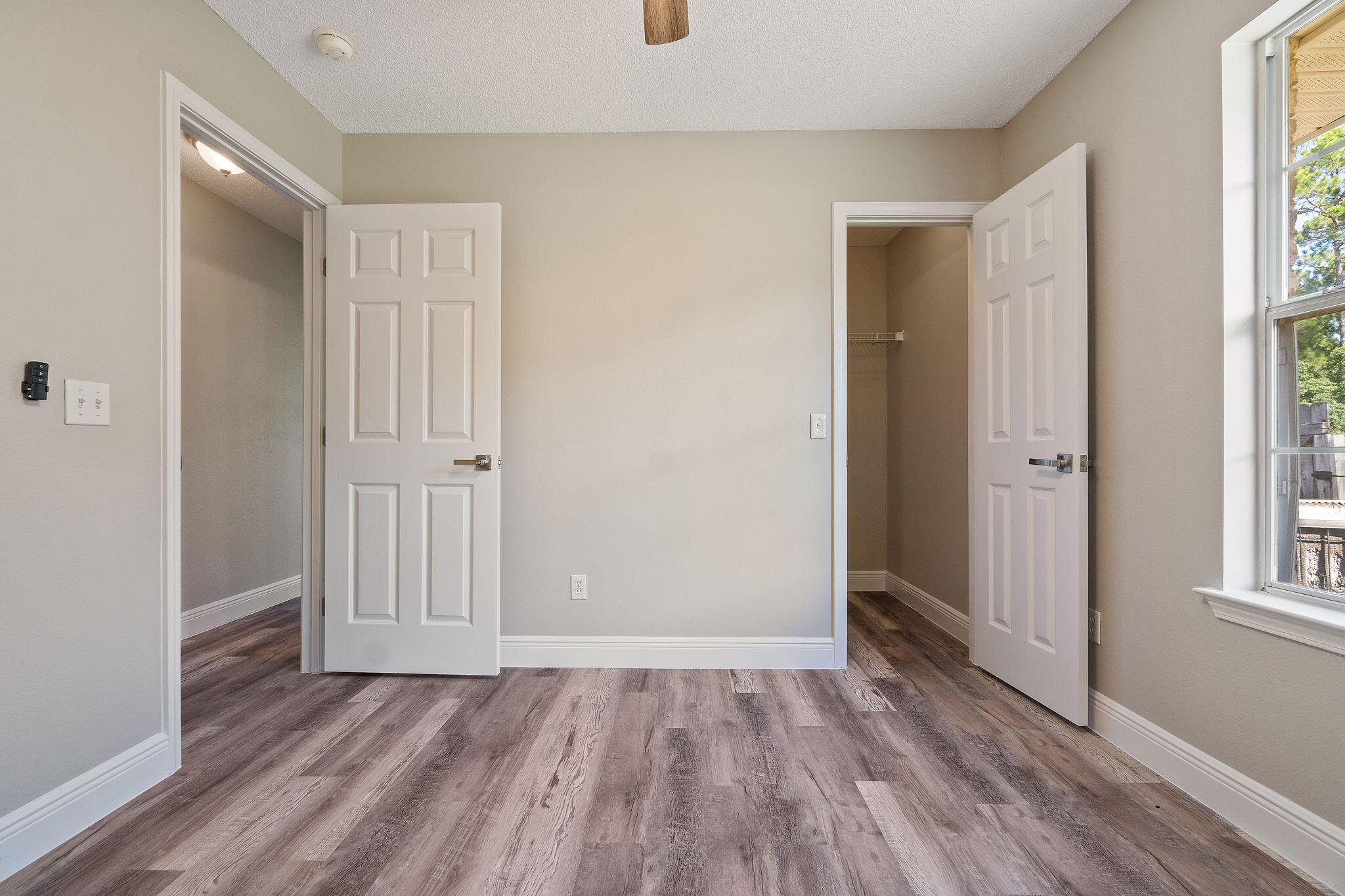 2005 Cardinal Lane Navarre, FL 32566 - Photo 36 of 63 an empty room with wooden floor and windows