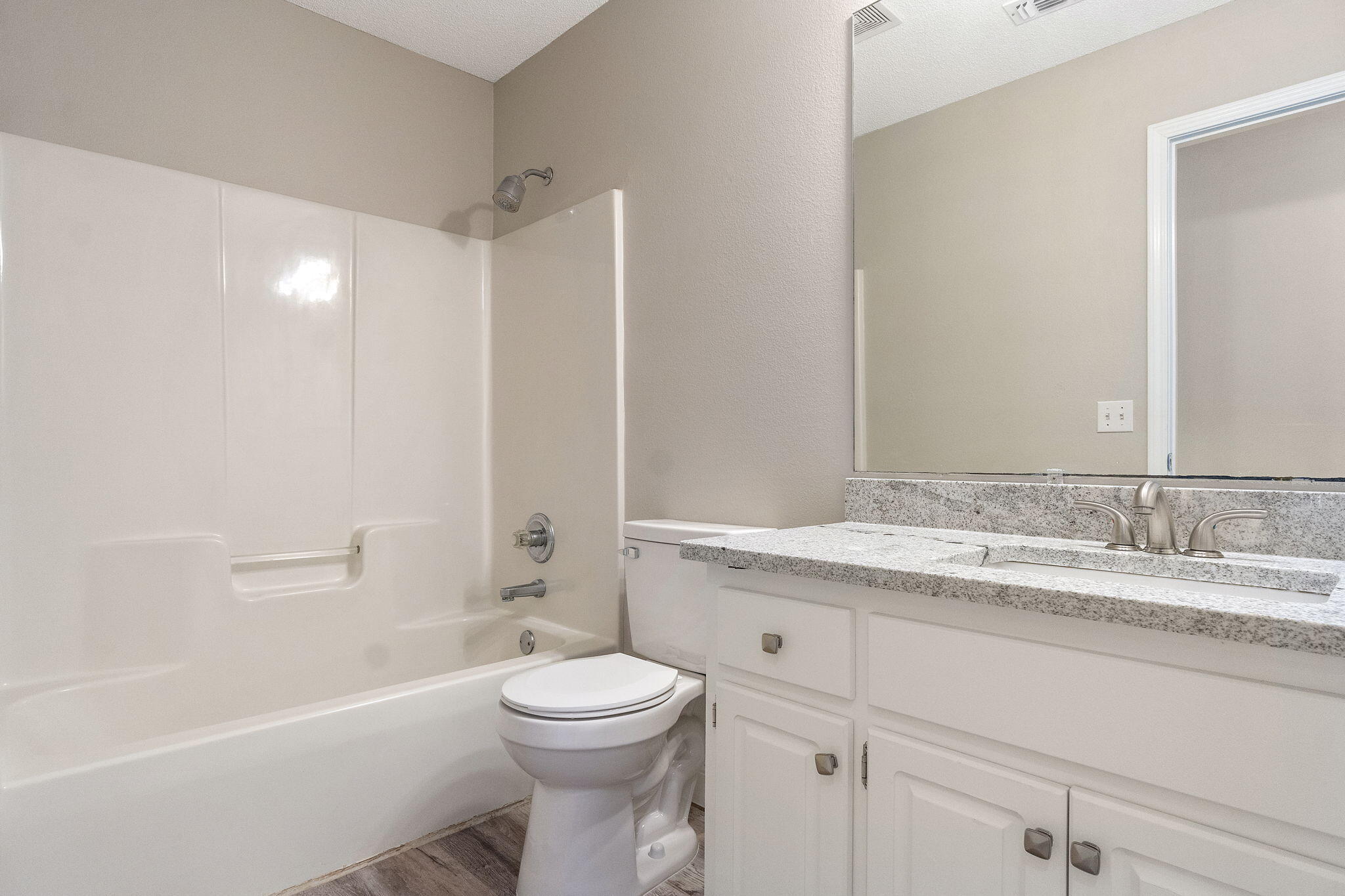 2005 Cardinal Lane Navarre, FL 32566 - Photo 37 of 63 a bathroom with a granite countertop toilet a sink and a bathtub