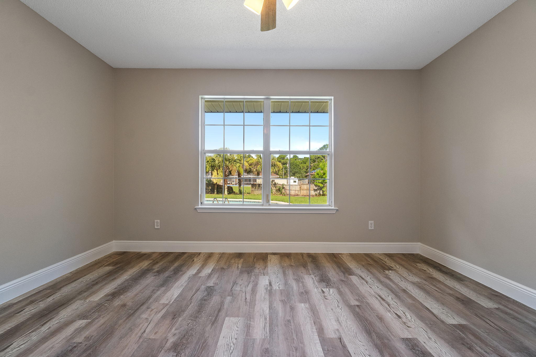 2005 Cardinal Lane Navarre, FL 32566 - Photo 38 of 63 wooden floor in an empty room with a window